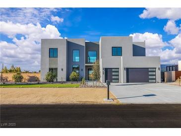 Modern two-story home featuring a minimalist design, desert landscaping, and a spacious two car garage at 2827 Richmar Ave, Henderson, NV 89074
