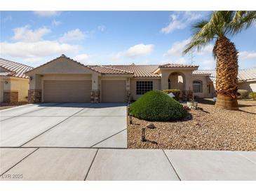 Charming single-story home with a three car garage, desert landscaping, and a well manicured lawn at 3561 Yorba Linda Dr, Las Vegas, NV 89122