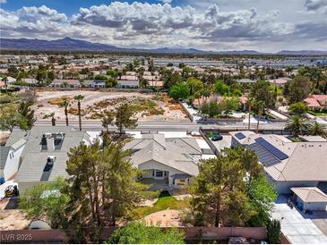 Expansive aerial view of the home with mature trees and beautiful landscaping in a desert landscape at 3710 E Oquendo Rd, Las Vegas, NV 89120