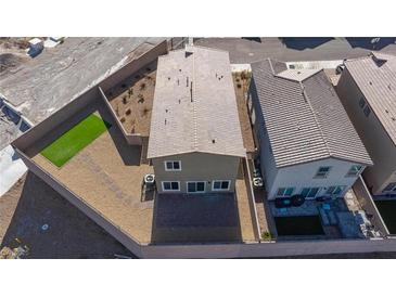 Aerial view of backyard with patio, landscaped area, and artificial turf at 5204 Sunstone Mesa Dr, Las Vegas, NV 89166