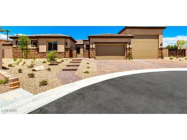 Charming single-story home with a stone facade, desert landscaping, and a two-car garage in a sunny setting at 5722 Christian Creek Ct, Las Vegas, NV 89149