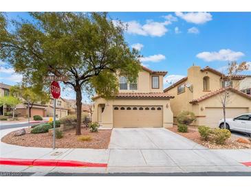 Charming two-story home featuring a tile roof, two-car garage, and desert landscaping at 689 Lucky Pine St, Henderson, NV 89002