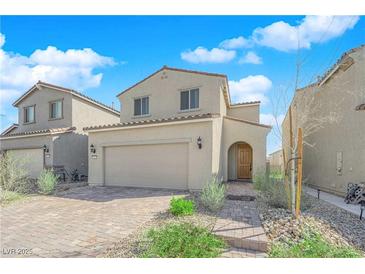 Charming two-story home featuring desert landscaping, a two-car garage, and a welcoming front entrance at 7022 Feather Hill St, North Las Vegas, NV 89086