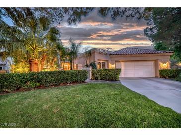 Charming single-story home featuring a well-manicured lawn, mature landscaping, and a two-car garage at 7889 Harbour Towne Ave, Las Vegas, NV 89113