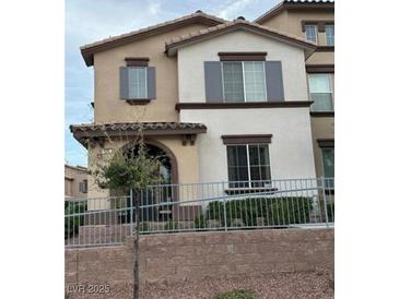 Charming two-story townhome with neutral stucco, gray shutters, and a well-maintained front yard at 11489 Belmont Lake Dr # 106, Las Vegas, NV 89135