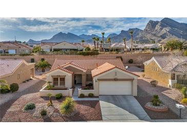 Charming single-story home boasts a terra cotta tile roof and low-maintenance desert landscaping against a mountain backdrop at 2345 Hot Brook Point St, Las Vegas, NV 89134