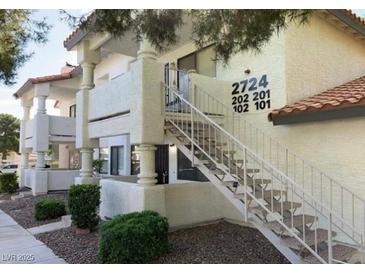 Apartment building featuring outdoor stairways leading to upper-level units at 2724 Otter Creek Ct # 101, Las Vegas, NV 89117