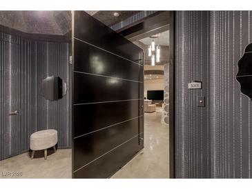 Modern condo entryway featuring a large door, textured walls, and a glimpse into the living space at 2777 Paradise Rd # Ph 3001, Las Vegas, NV 89109