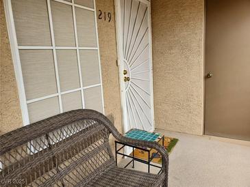 Welcoming front porch featuring a cozy wicker bench, creating an inviting outdoor space at 3455 Erva St # 219, Las Vegas, NV 89117