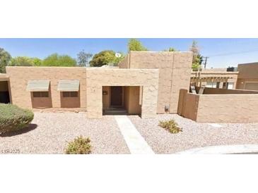 Charming single-story home featuring a stone-accented entrance and desert landscaping at 4304 Gretna Green Ct, Las Vegas, NV 89110