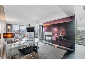 Bright living room featuring modern decor, a sleek fireplace, and city views at 4381 West Flamingo Rd # 8322, Las Vegas, NV 89103