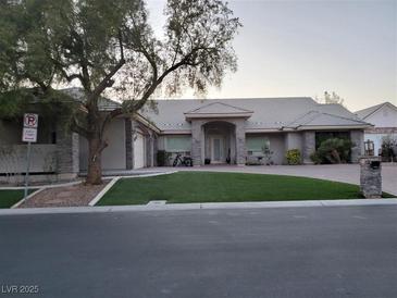 Charming single-story home featuring manicured front yard, elegant stone accents, and a welcoming arched entryway at 4739 Laurel Canyon St, Las Vegas, NV 89129