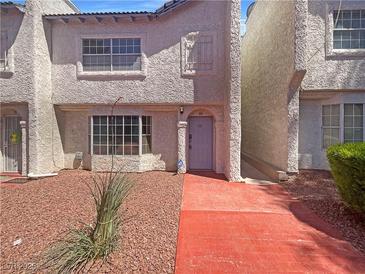 Charming two-story townhome featuring a well-maintained front yard and inviting entrance, perfect for comfortable living at 5383 Mountain Vista St # 20, Las Vegas, NV 89120