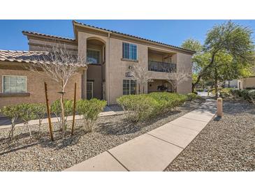 Inviting condominium exterior features a well-maintained facade, desert landscaping, and a private balcony at 6745 Caporetto Ln # 104, North Las Vegas, NV 89084