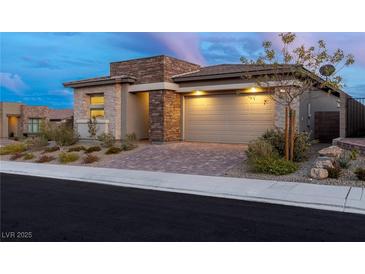 Beautiful single-story home featuring a stone facade, brick driveway, and a well-maintained front yard at 912 Calluna Hills Ln, Las Vegas, NV 89138