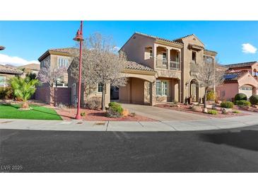 Charming two-story home featuring a portico, balcony, manicured landscaping, and a spacious driveway at 2908 Ferrand Ct, Henderson, NV 89044