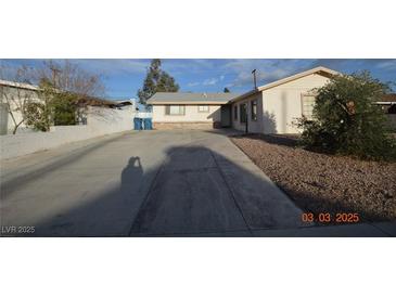 Charming single-story home with a long driveway and low-maintenance landscaping at 301 Falcon Ln, Las Vegas, NV 89107