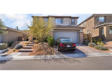 Charming two-story home showcasing a desert landscape and a two-car garage at 397 American Dipper St, Las Vegas, NV 89138