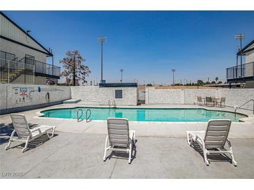 Inviting community pool with lounge chairs for relaxing in the sun at 4600 University Center Dr # 99, Las Vegas, NV 89119