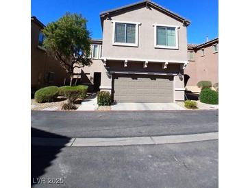 Two story home featuring an attached 2 car garage and desert landscaping at 684 Calamus Palm Pl, Henderson, NV 89011