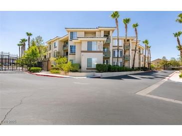Beautiful condo building with lush landscaping and palm trees providing a relaxing atmosphere at 7151 S Durango Dr # 211, Las Vegas, NV 89113