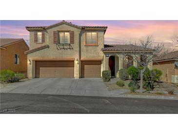 Two-story home featuring a three-car garage and desert landscaping at 9416 Highview Rock Ct, Las Vegas, NV 89149