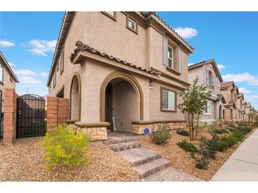 Charming two-story stucco home with an arched entry and well-maintained landscaping in a desirable neighborhood at 1364 Cerulean Ave, Henderson, NV 89002