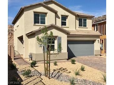 Charming two-story home with a two-car garage and low-maintenance desert landscaping at 176 Brighton Hills Ave, Henderson, NV 89002