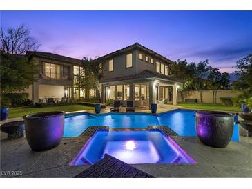 Inviting backyard pool and spa with covered patio, perfect for relaxing evenings and outdoor entertaining at 320 Lorelei Rock St, Las Vegas, NV 89138