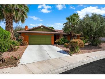Charming single-story home featuring a two-car garage, desert landscaping, and mature palm trees at 4592 Cabo Ln, Las Vegas, NV 89121