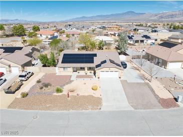 Inviting single-story home featuring solar panels and a well-maintained desert landscape at 4910 Marywood Ct, Pahrump, NV 89061