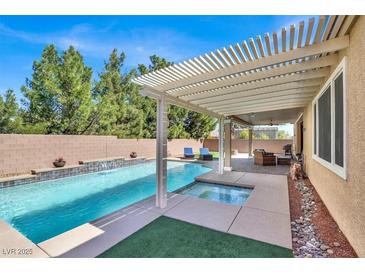 Inviting backyard pool and spa with a covered patio, perfect for outdoor relaxation and entertaining at 7420 Zonal Ave, Las Vegas, NV 89131