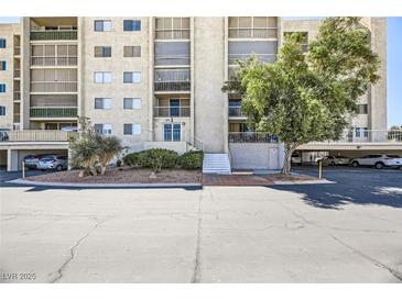 Condo building exterior shows well maintained facade, mature landscaping and ample parking available for residents and guests at 745 N Royal Crest Cir # 158, Las Vegas, NV 89169
