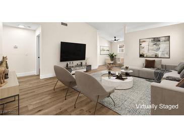 Bright living room with modern decor, featuring a comfortable sofa, chairs, and stylish coffee table on a textured rug at 7554 Violet Vista Ave # 201, Las Vegas, NV 89130