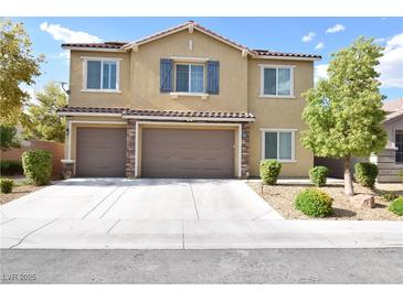 Inviting two-story home featuring a neutral color palette, shutters, attached two-car garage and landscaped front yard at 8084 Bosco Bay Ave, Las Vegas, NV 89113