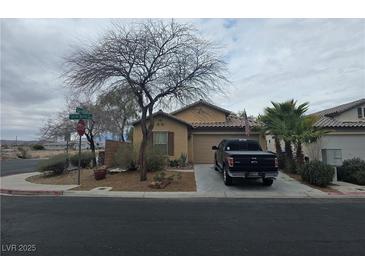 Inviting single-story home with desert landscaping, a two car garage, and a well-maintained lawn at 8993 Secret Valley St, Las Vegas, NV 89139