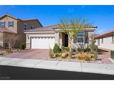 Charming single-story home featuring a paver driveway, two-car garage, and desert landscaping at 984 Brilliant Meadow Ave, North Las Vegas, NV 89086