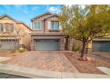 Charming two-story home with a paver driveway and a well-manicured front yard, perfect for Gathering living at 10548 Nantucket Ridge Ave, Las Vegas, NV 89166