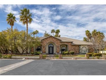 Beautiful single story home with manicured yard, desert landscaping, and stone accents at 1901 Rosemere Ct, Las Vegas, NV 89117