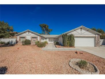 Charming single-story home featuring a well-manicured desert landscape and an attached two-car garage at 2004 Canterbury Dr, Las Vegas, NV 89119