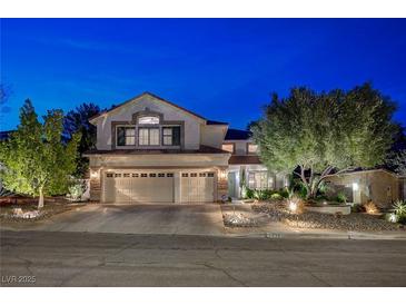 Charming stucco two-story home with a three car garage and manicured landscaping in the front yard at 2236 Midvale Ter, Henderson, NV 89074