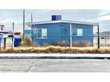 Quaint single-story exterior featuring a fenced yard, providing a sense of security and privacy at 703 Madison Ave, Las Vegas, NV 89106