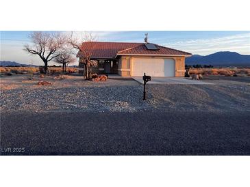Charming single-story home with a well-maintained yard and two-car garage at 1900 E Highland Ave, Pahrump, NV 89048