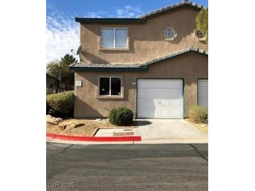 Charming townhome with attached garage and desert landscaping at 5273 Wave Dancer Ln, Las Vegas, NV 89118