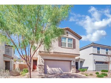 Inviting two-story home with a charming facade, complemented by a well-maintained front yard and mature tree at 6945 Trevelez St, Las Vegas, NV 89149