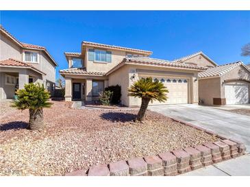 Charming home featuring a desert landscape, an attached three-car garage, and a welcoming front porch at 7836 Pinnochio Ave, Las Vegas, NV 89131