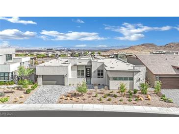 Modern single-story home with stone accents, desert landscaping, and a two-car garage at 818 Calluna St, Las Vegas, NV 89138