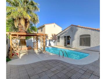 Beautiful pool with a charming pergola and seating area, perfect for outdoor relaxation at 1004 Country Skies Ave, Las Vegas, NV 89123