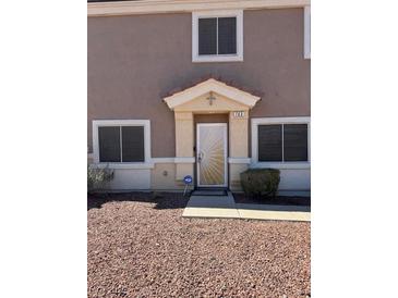 Inviting home entrance with a security screen door and well-maintained landscape at 1066 Slate Crossing Ln # 3, Henderson, NV 89002