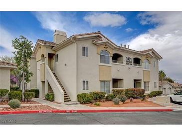 Attractive condo featuring two-story design, well-maintained landscaping, and a welcoming entrance at 1401 Red Crest Ln # 201, Las Vegas, NV 89144
